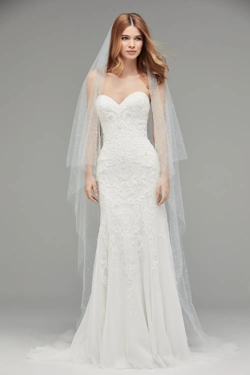 Plus size model wearing a white Strapless gown