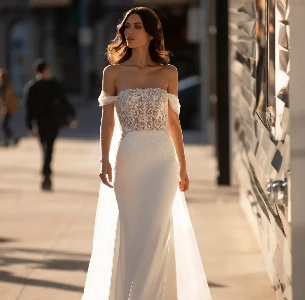 Plus size model wearing a white Strapless gown
