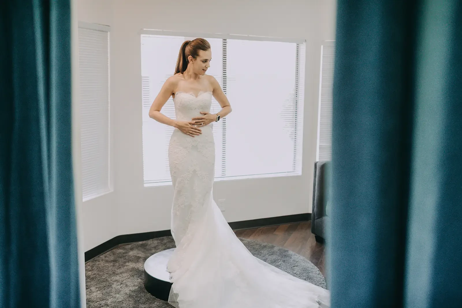 Photo of bride trying on a wedding dress